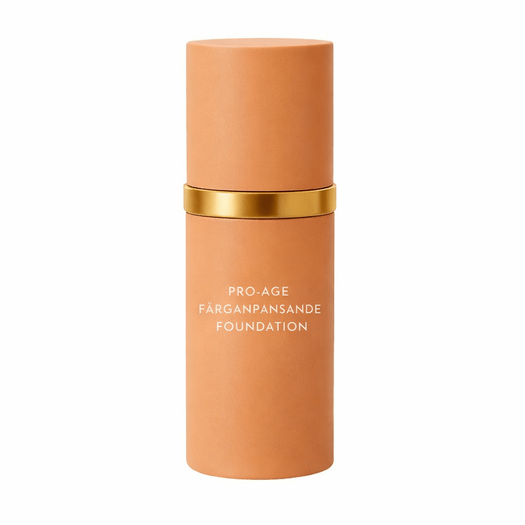 Pro-age färganpassande foundation produktflaska med guldlock och beige design.