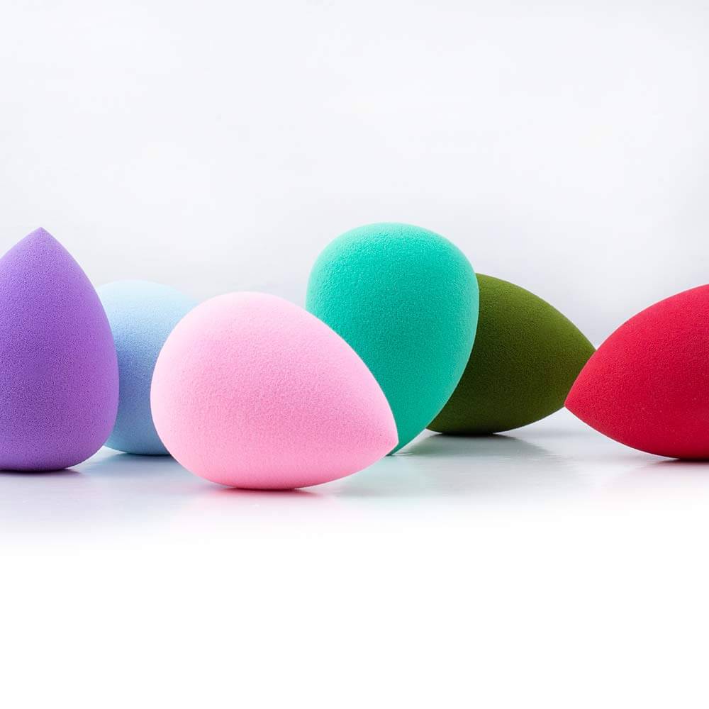 Axiva Perfect Blender – Flawless Makeup Sponge in various colors including pink, green, red, and purple.